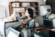 A woman sitting at a counter in a coffee shop.