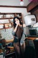 A woman standing in a kitchen next to a counter.