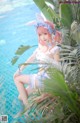 A woman in a bunny costume sitting on the edge of a pool.