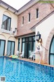 A woman standing on the edge of a swimming pool.