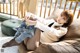 A woman sitting on a bean bag chair with her legs crossed.