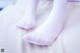 A close up of a person's feet in white socks.