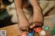 A person sitting at a table with poker chips on it.