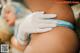 A woman getting a tattoo on her thigh. 