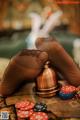 A person sitting at a table with poker chips and a bell.