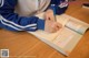 A person sitting at a table writing in a notebook.