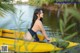 A woman in a yellow kayak on a lake.