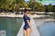 A woman in a polka dot swimsuit standing on a dock.