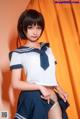 A woman in a school uniform posing for a picture.