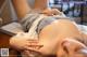 A woman laying on top of a table next to a mannequin.