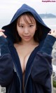 A woman in a blue hoodie posing for the camera.