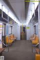 A subway train with yellow seats and a door.