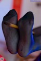 A pair of black and blue stockings with a pencil sticking out of them.