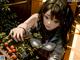 A woman sitting on a bench next to a bunch of fruit.